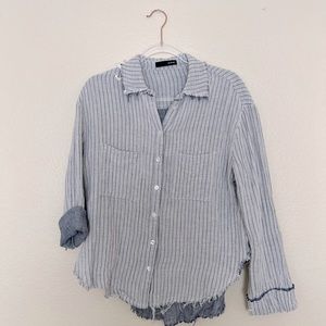On blue, blue and white button up women’s top.
